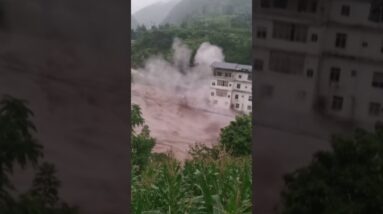 Building partially collapses amid rushing floodwaters in China