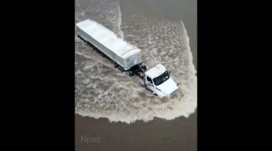 Semi-trailer drives through floodwaters on Texas highway