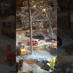 Montreal snow plow pushes car stuck in snow bank