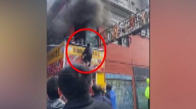 People jump from windows to escape building fire in China