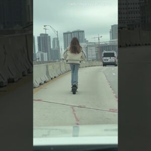 Woman rides scooter on Miami highway