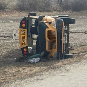 Police say a child was left pinned underneath a school bus rollover near Woodstock, Ont.
