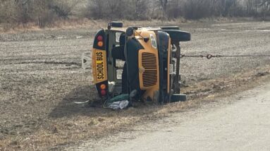Police say a child was left pinned underneath a school bus rollover near Woodstock, Ont.