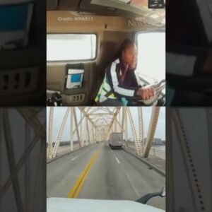 Truck driver crashes and dangles from bridge